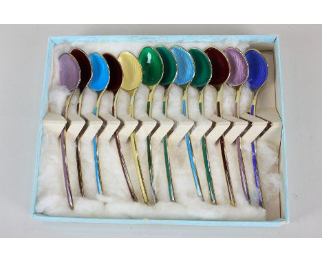 A matched set of twelve Norwegian silver gilt and harlequin enamel coffee spoons, maker N M Thune, marked 925, two marked Ste