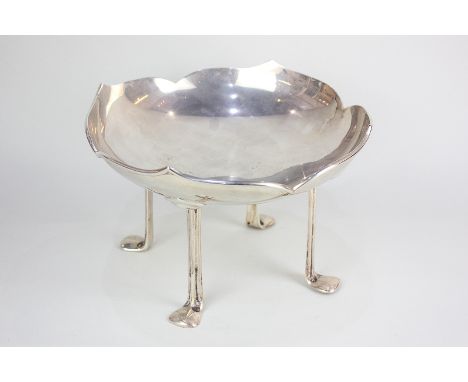 A George V Art Nouveau silver circular bowl with scalloped border, on four extended supports with feet, maker William Hutton 