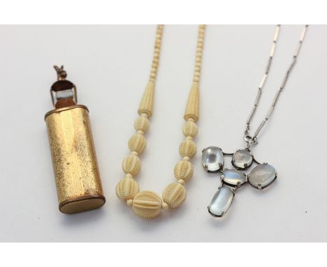 A silver and moonstone necklace, a carved bone necklace, and a base metal scent phial
