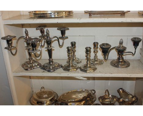 A pair of silver plated two-branch candelabra with scroll branches, removable sconces, on baluster stems, 23cm high, another 