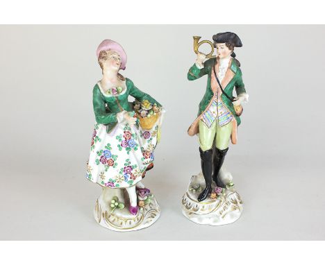 Two similar Sitzendorf porcelain figures of a lady flower seller and a boy with bugle, both in green jackets, tallest 19cm, (