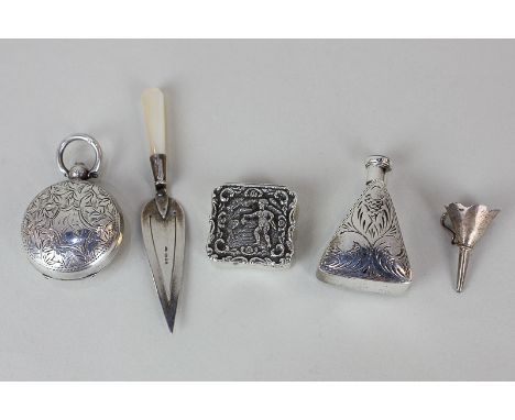 An Elizabeth II silver pill box with embossed cherubic design, maker Douglas Pell Silverware, London 1957, a silver trowel pa