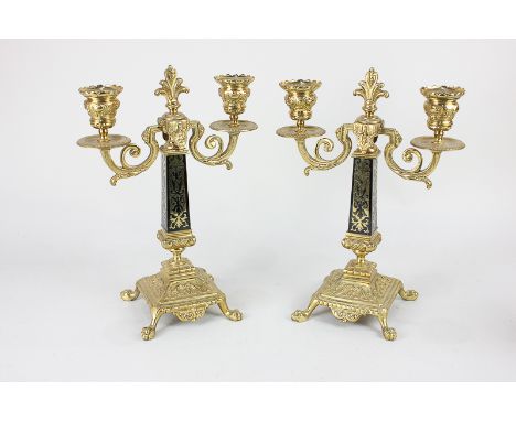 A pair of Louis XVI style gilt metal two-branch candelabra,  two scroll branches with urn shaped sconces on tapering baluster