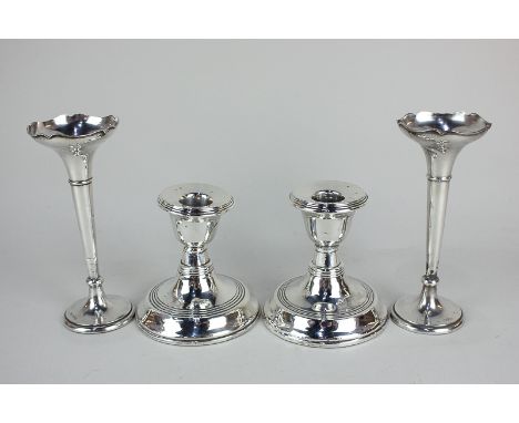 A pair of George V silver dwarf candlesticks, maker J C Ltd, Birmingham, 1922, together with a pair of silver bud vases, make