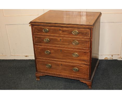 A mahogany miniature chest, the urn and fan patera inlaid top above four graduated long drawers, on ogee bracket feet, conver