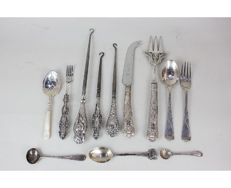 A George III silver condiment spoon, London 1804, a silver christening set of fork and spoon, three button hooks, a caddy spo