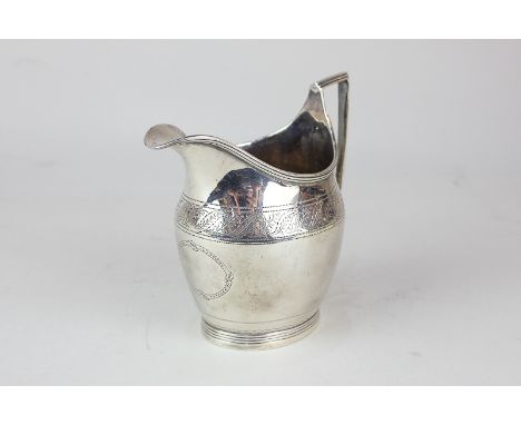 A George V silver cream jug, maker Jay Richard Attenborough Co Ltd, Chester 1932, with chased design and vacant cartouche, 4o