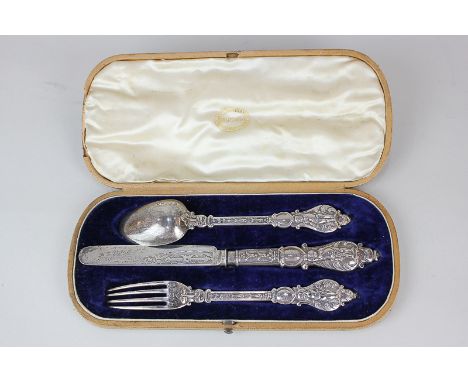 A Victorian silver cased christening set of knife, fork and spoon, maker Martin Hall & Co, Sheffield 1855, with figural and f
