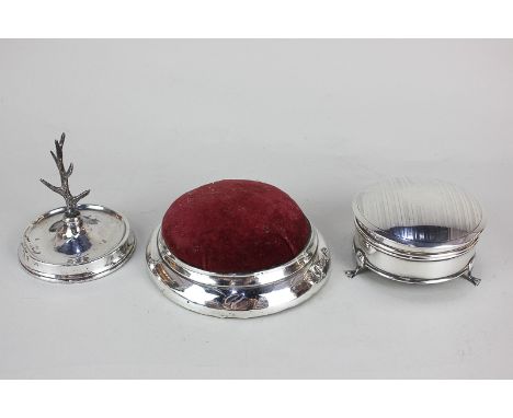A George V silver dressing table circular box, a silver ring tree and a large silver pin cushion (all marks worn)
