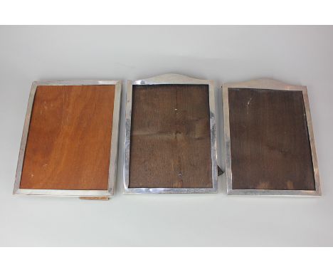 A pair of George V silver photograph frames rectangular shape with dome tops, 23cm, Birmingham 1919, and another rectangular 