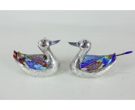 A pair of Chinese white metal and enamel duck shaped sauce or condiment pots with multi-coloured enamel wings and eyes, the b