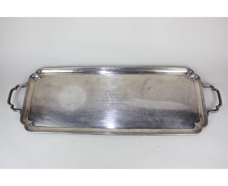 A George VI silver two-handled tray, rectangular shape with moulded border and shaped corners, engraved centre with presentat