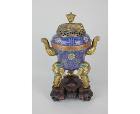 A Chinese brass and enamel incense burner, circular form with pierced cover cast with a recumbent elephant, two handles in th