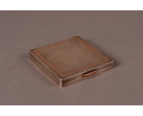 A George VI Silver and Silver Gilt Compact, of square design with engine turned design, gold trim and button, Birmingham 1949