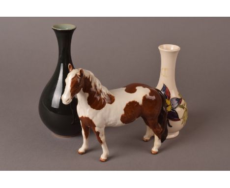 A Beswick porcelain horse figure, in white and brown, together with A white ground Moorcroft vase, with floral decoration anf