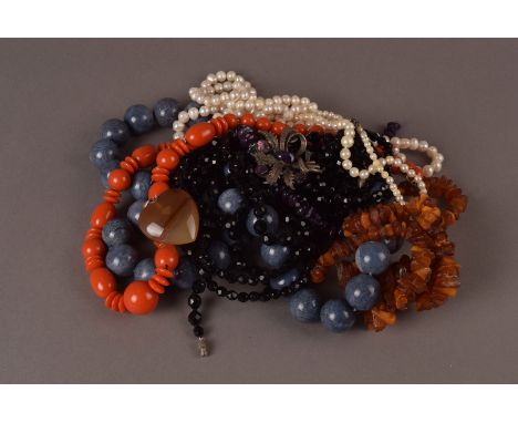 A collection of various jewellery, including several pairs of earrings, two pearl necklaces, a rough amber bead necklace, an 