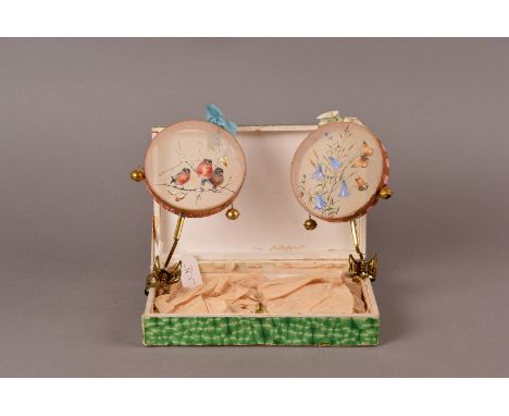 A pair of pram rattles, in the form of miniature tambourines with painted silk panels of painted butterflies, bluebells, pres