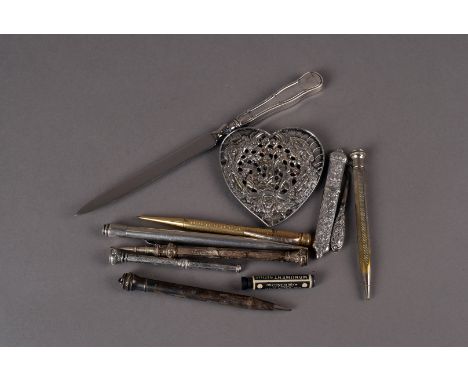 An Edwardian period silver heart shaped button or buckle, together with a silver needle case and silver handled button hook, 
