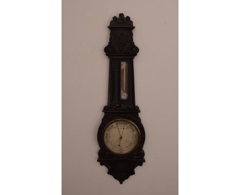 An Irish stained Oak Barometer, silvered dial by Yeates & Son Dublin, black stained finish with Shamrock, Celtic cross , harp