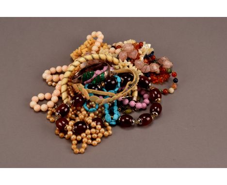 A collection of bead necklaces, including a rough amber bead example, a rose quartz necklace, hardstone and other examples, t