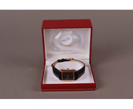 A Must De  Cartier ladies wrist watch,  the silver quartz Tank watch with black face and gilt lettering, and sapphire cabacho