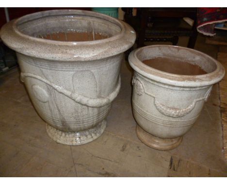 A graduated pair of ceramic planters, 64 cm H, and smaller 