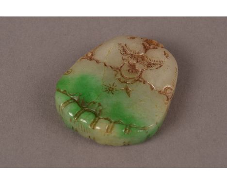 A Chinese Jade oval pendant,  modelled as a pair of rising fish from a pool in two tones of green 