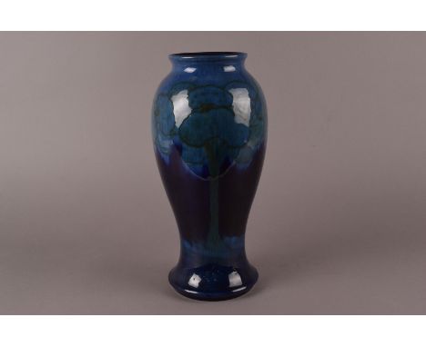 A William Moorcroft Moonlit Blue pottery vase, of baluster form and designed c.1930 by William Moorcroft 30.5 cm H  There are