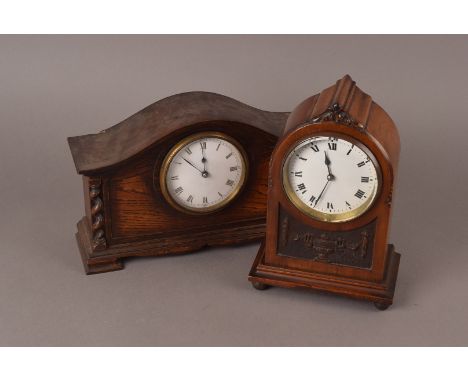 A carved Mahogany mantle clock, of lancet type and neo classical panel, French 8 day barrel  movement together with a similar