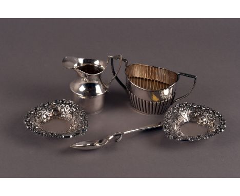 A pair of late Victorian silver pierced dishes, together with a George V silver cream jug, a helmet shaped sugar basin and a 