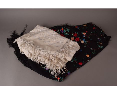 A vintage Spanish shawl, the black ground having bright floral decoration, together with a white shawl and a Middle Eastern K