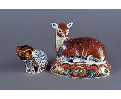 Two Royal Crown Derby ceramic paperweights, one of a laying deer and the other of a ram, both having different decoration and