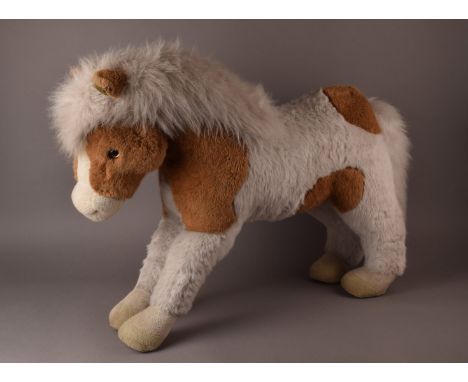 A large vintage Merrythought toy pony, in white and brown, with fluffy mane, bearing label, kindly donated by Special Auction