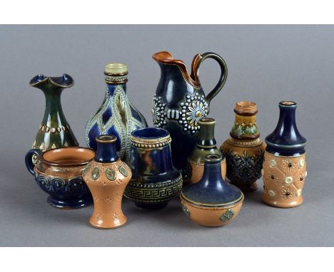 A group of ten miniature Doulton Lambeth ceramic vases and jugs, all various designs, sizes and colours, all marked to base (
