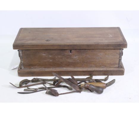 A wooden tool box containing tools such as filers, allen keys, and other. Wooden tool box has metal handles on either side an