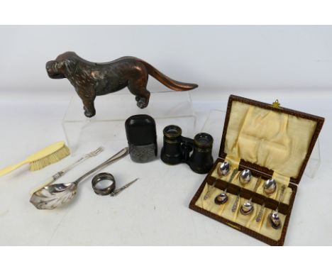 Lot to include a cast iron nutcracker in the form of a dog, hip flask, silver napkin ring, silver handled button hook, plated
