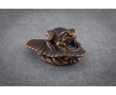 A WOOD NETSUKE OF A TOAD ON SANDAL Japan, 19th century, Edo period (1615-1868), signed, believed to be MASANAO. Well-carved a