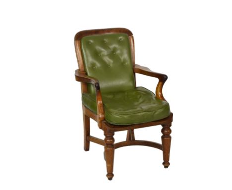 A mahogany green leather button back open arm chair with padded buttoned back and out swept arm rests over a shaped buttoned 