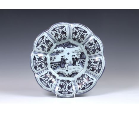 A Faience nonagonal lobed saucer dish with broad everted rim and blue decoration on white tin glaze, the rim with decorated f