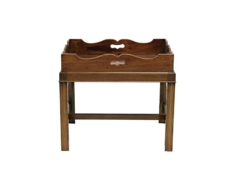 An English 19th century mahogany butler's tray on stand with shaped raised gallery and pierced hand holes on a separate stand