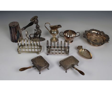 A group of small silver plated table items to include two toast racks, a pair of wooden handled silent butlers, wine taster/ 