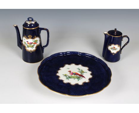 A Royal Worcester porcelain coffee pot and cover 7½in. (19cm.) high, together with a lidded milk jug and matching cake stando
