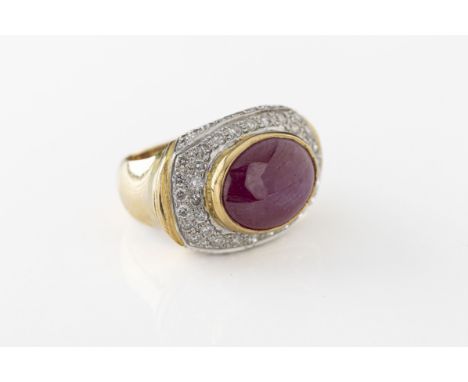 A yellow gold ruby and diamond boat-head dress ring the oval cabochon star ruby approx 10mm x 12mm x 4.4mm, displaying a fain