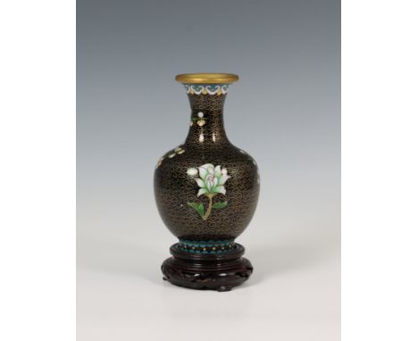 A Japanese cloisonné enamel baluster vase with a floral design on a wooden stand, 6in. (15.2cm.) high.