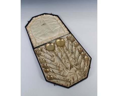 A set of twelve silver gilt late 19th century teaspoons 5in. length, with two matching silver gilt serving spoons by David An