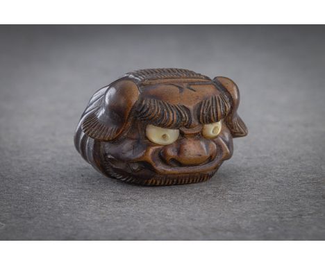 A WOOD MASK NETSUKE OF A SHISHI HEAD Unsigned, Japan, 19th century, late Edo period (1615-1868) Well carved with piercing pea