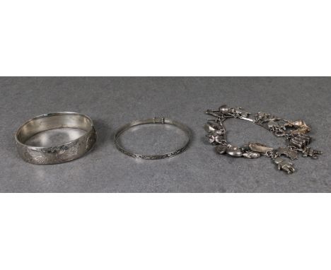 A silver charm bracelet having twenty charms, comprising a Guernsey can, cat, frog, sailing boat etc, together with a silver 
