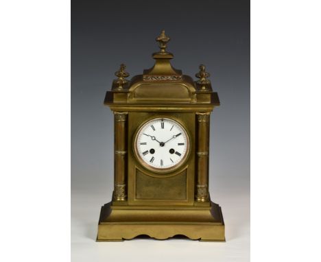 A French brass architectural mantel clock 19th century, the white Roman enamel dial fronting a two-train movement with outsid