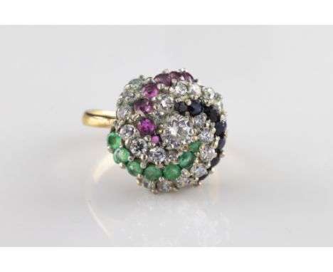 A 9ct yellow and white gold CZ, emerald, sapphire and ruby cocktail ring the domed circular head centered with a round brilli