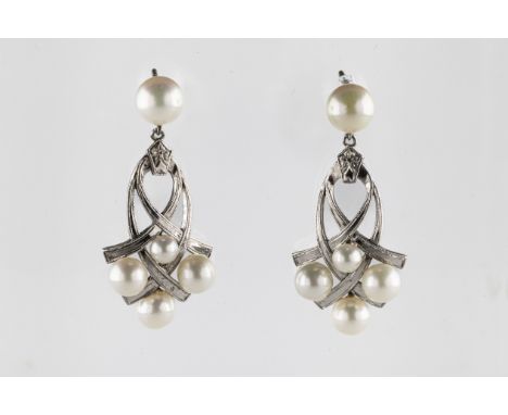 A pair of white metal Mikimoto pearl drop earrings set with four graduated cultured pearls, on an interlocking openwork frame